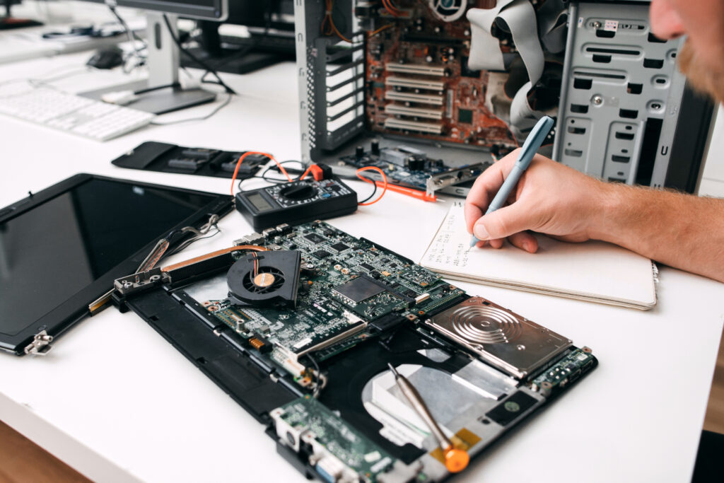 computer motherboard diagnostics close up programmer inspecting circuit note results paper electronic repair fix renovation concept computer motherboard diagnostics close up programmer inspecting circuit note results paper electronic repair fix renovation concept