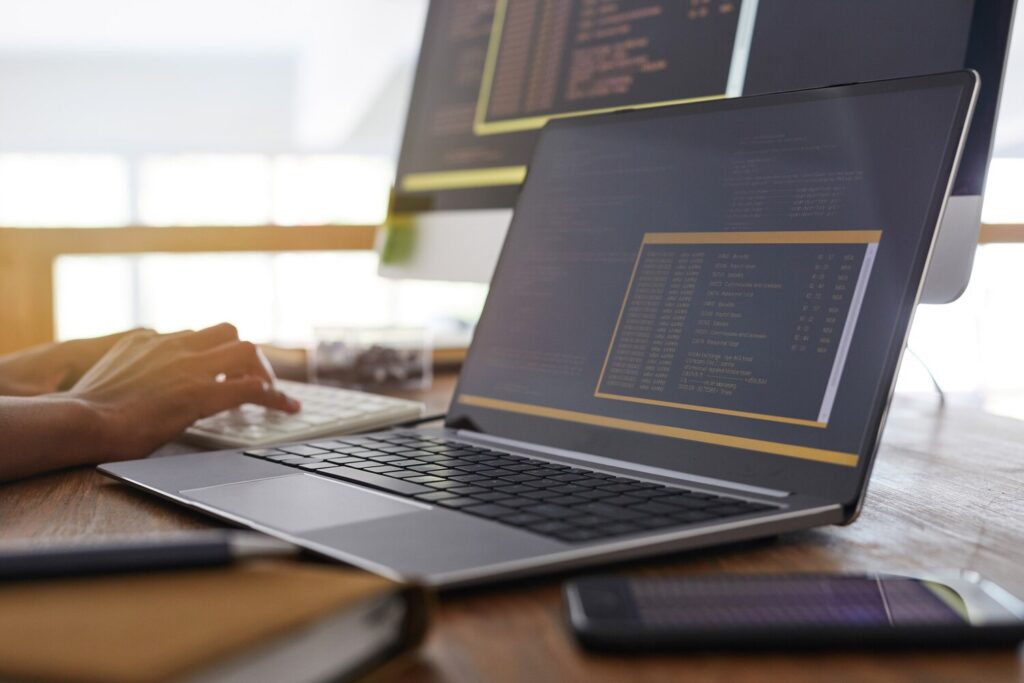 background image male hands typing keyboard with black orange programming code laptop screen foreground it developer concept copy space 236854 23796